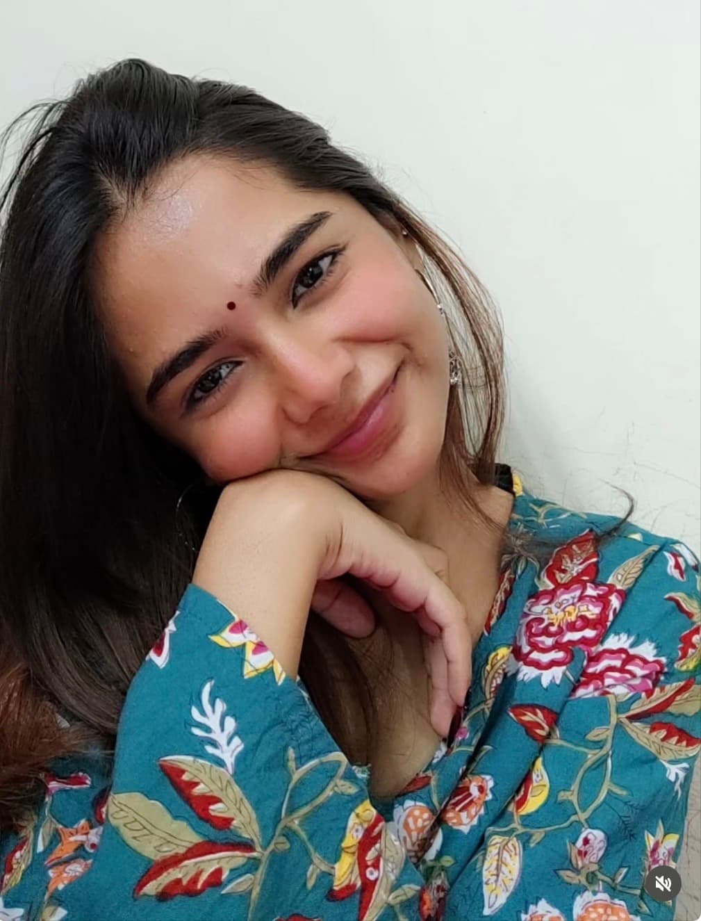 Kahkasha smiling in a teal floral outfit